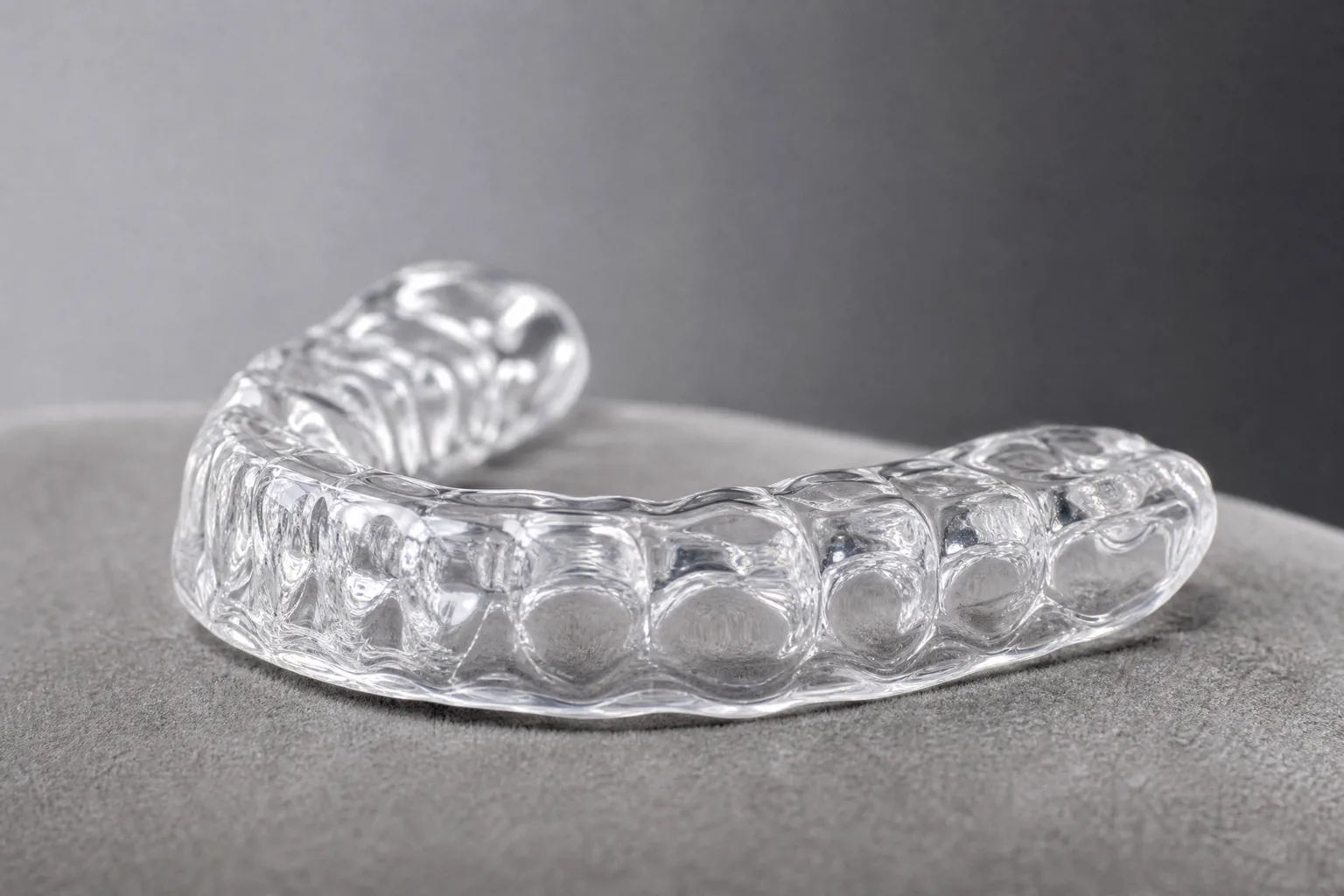 TMJ treatment in Scottsdale, dentist fitting a custom bite splint to relieve jaw pain