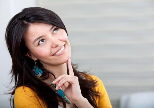 Woman pausing to think about whether a tooth twinge could be an early cavity