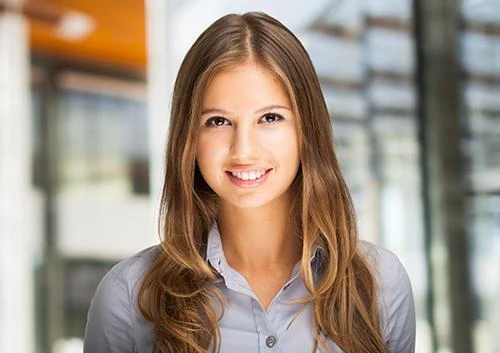 Young adult woman smiling, the age when wisdom teeth often become impacted